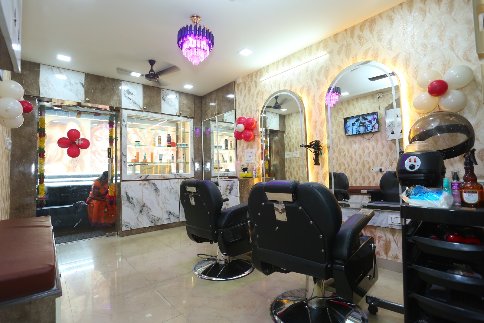 Salon interiors with chandelier and hair stations